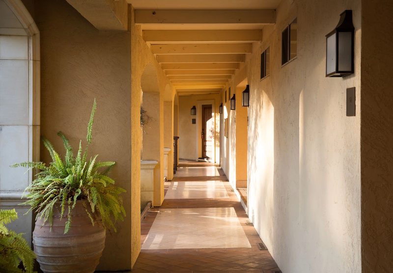 Light dances through a warm, California-inspired hallway | Hotel Yountville