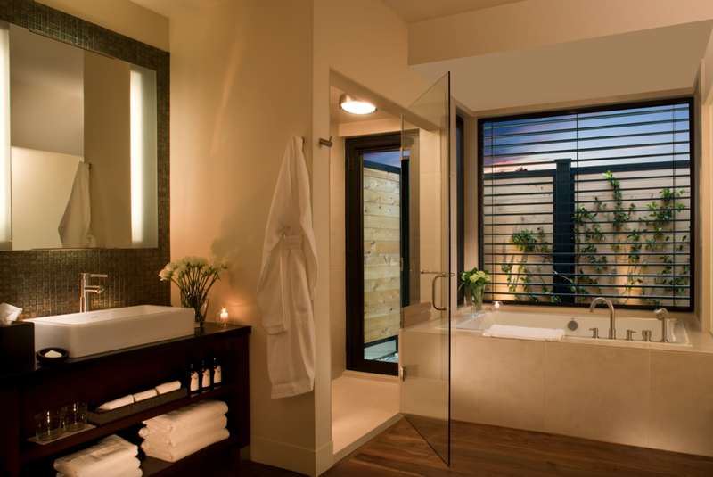 A warm neutral bathroom features a large tub, shower, and vanity area | Hotel Yountville