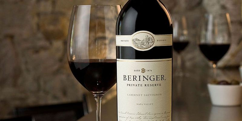 Bottle of Beringer Private Reserve Cabernet Sauvignon beside a wine glass.