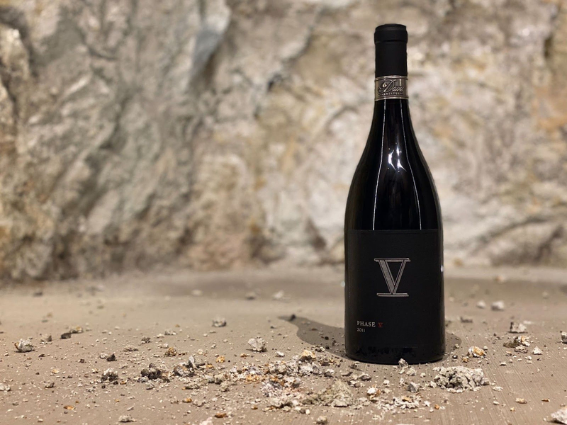  Davis Estates Phase V wine bottle displayed against a rustic stone background.