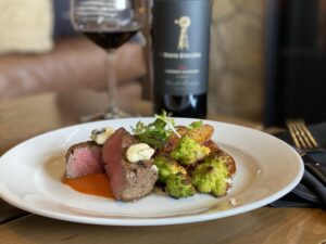 Steak and vegetables paired with wine at Davis Estates.